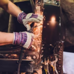 professional-repairman-worker-automotive-industry-welding-metal-body-car-with-sparks